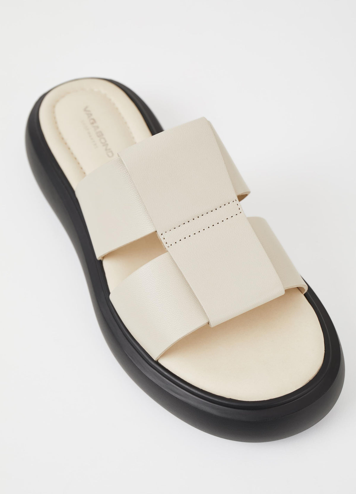 Off white leather slider with a black rubber sole