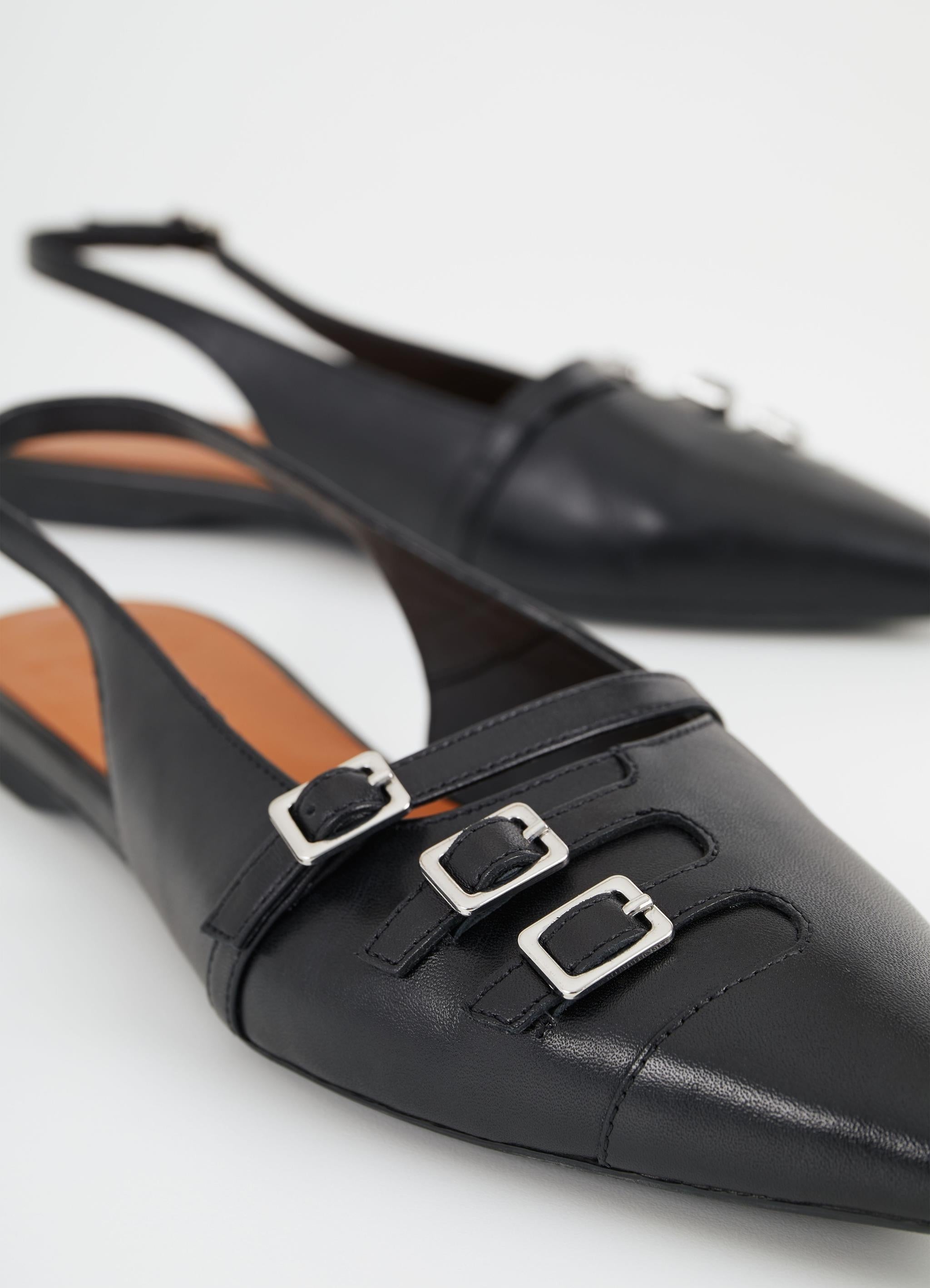 Black low slingbacks with silver buckle details