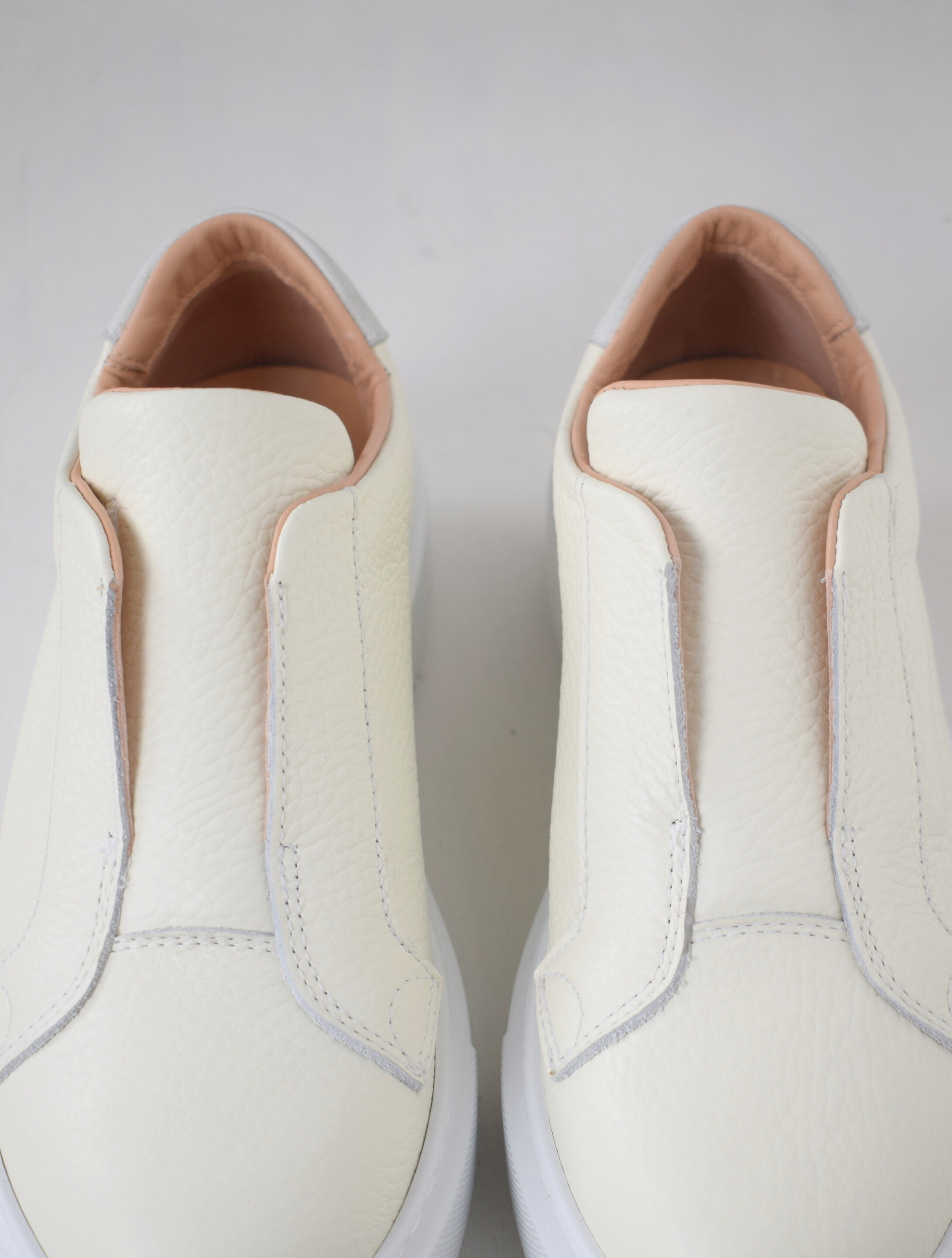 White platform trainers will elasticated side panels to make them easy to pull on