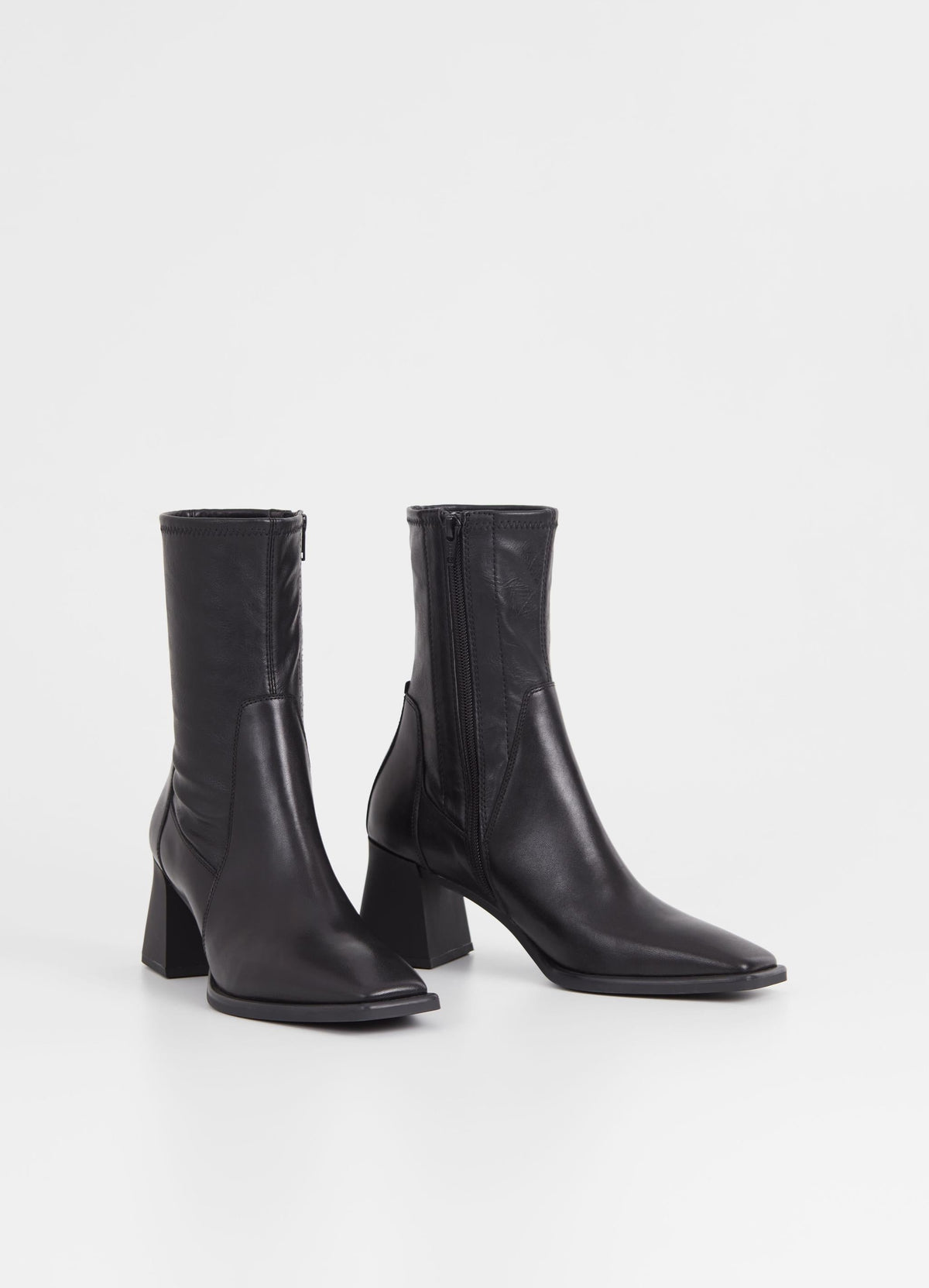 Mid-length inside zip black leather boot with flared block rubber heel and rounded square toe