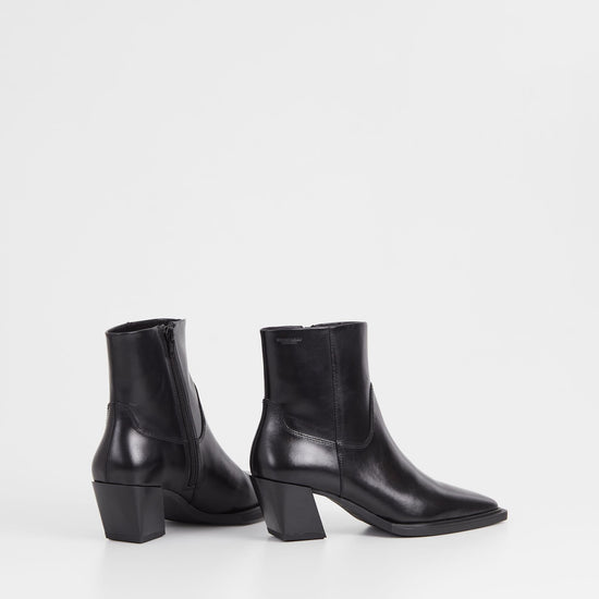 Western inspired slanted block heel black leather ankle boot