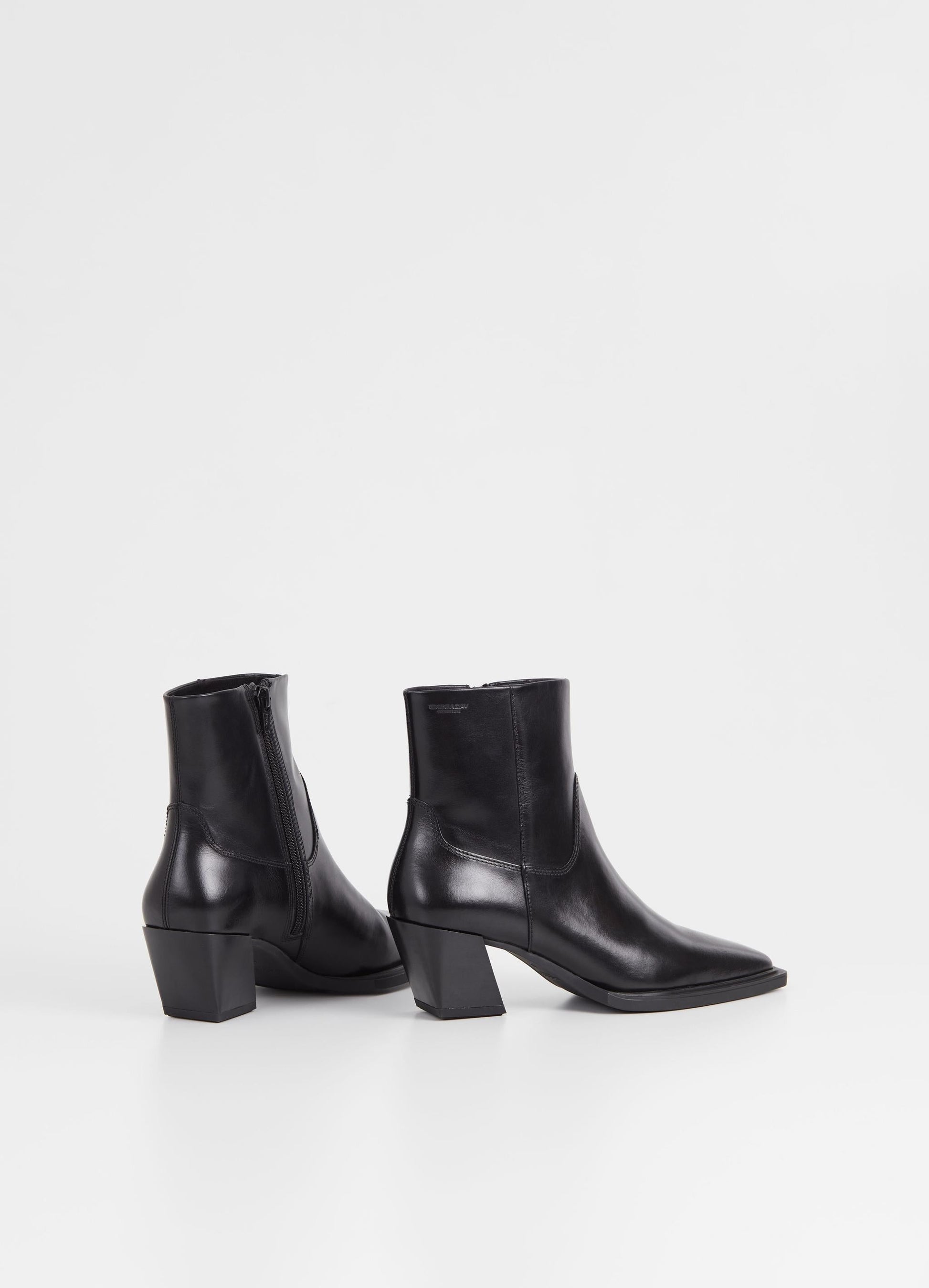 Western inspired slanted block heel black leather ankle boot