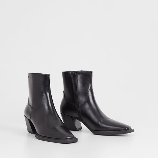 Western inspired slanted block heel black leather ankle boot