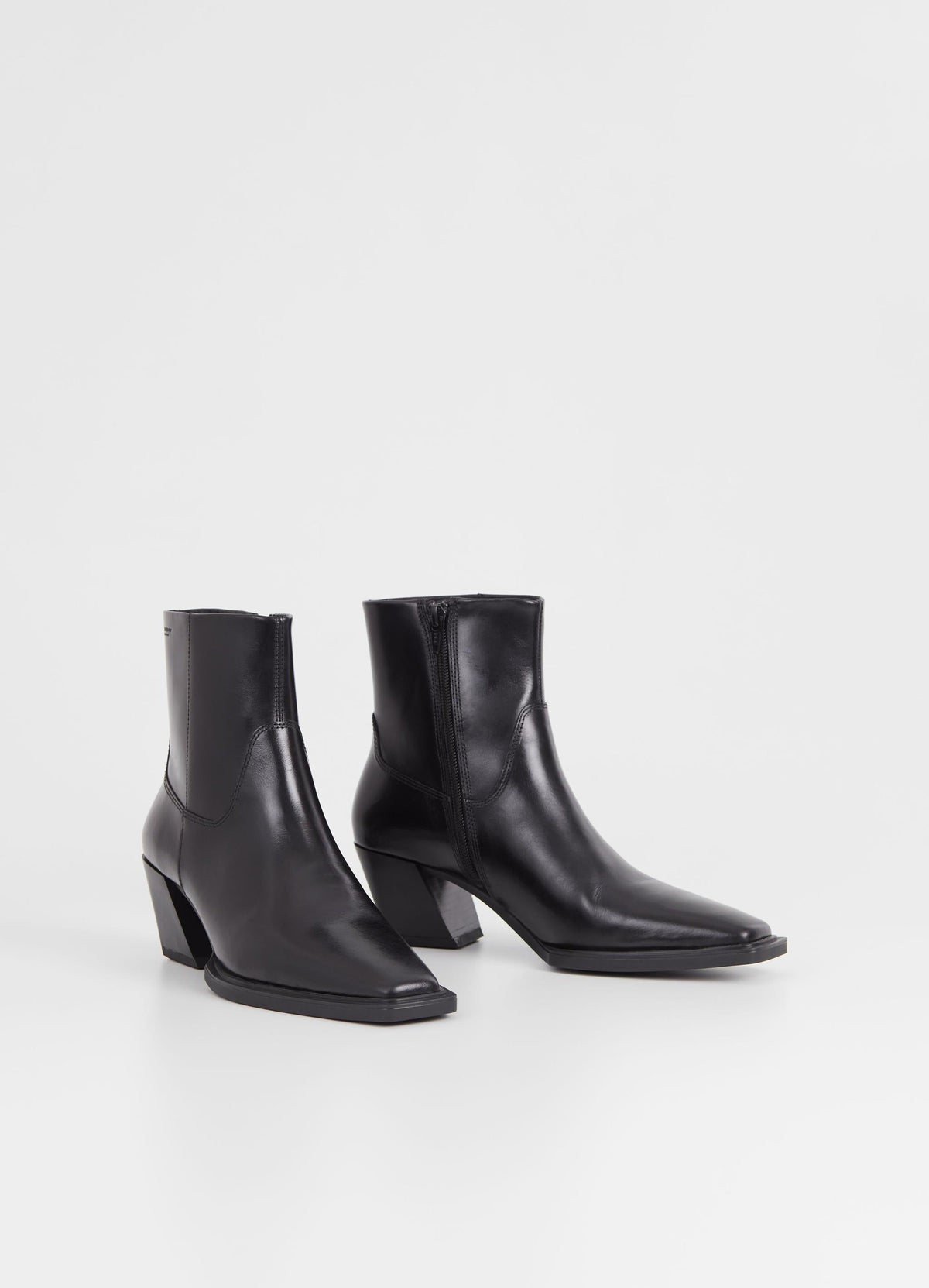 Western inspired slanted block heel black leather ankle boot