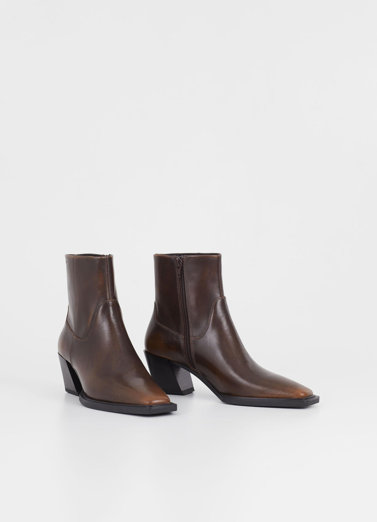 Dark brown western inspired boot with slanted stacked block heel and inside zip fastening