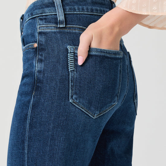 Close up of pocket detail of blue paige jeans