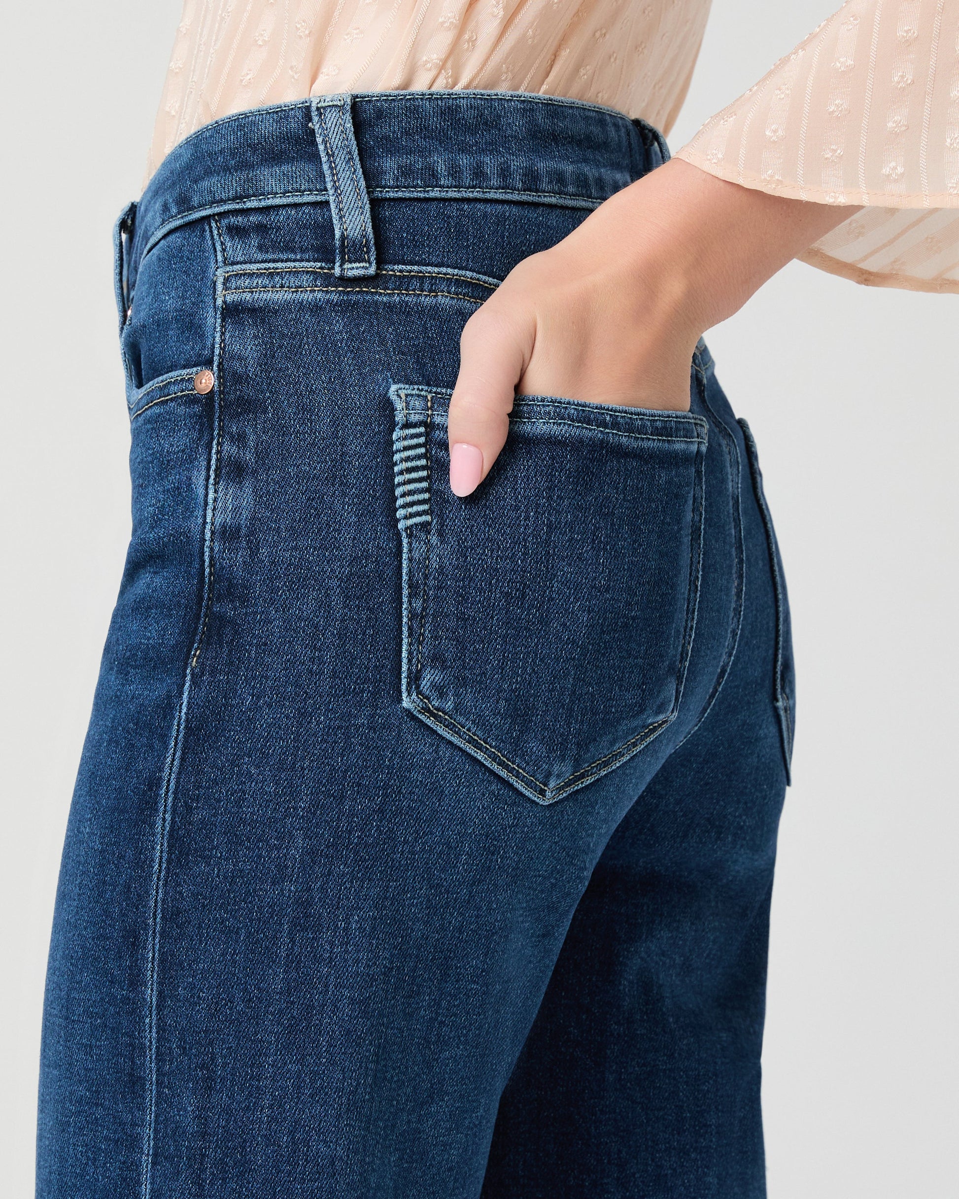 Close up of pocket detail of blue paige jeans