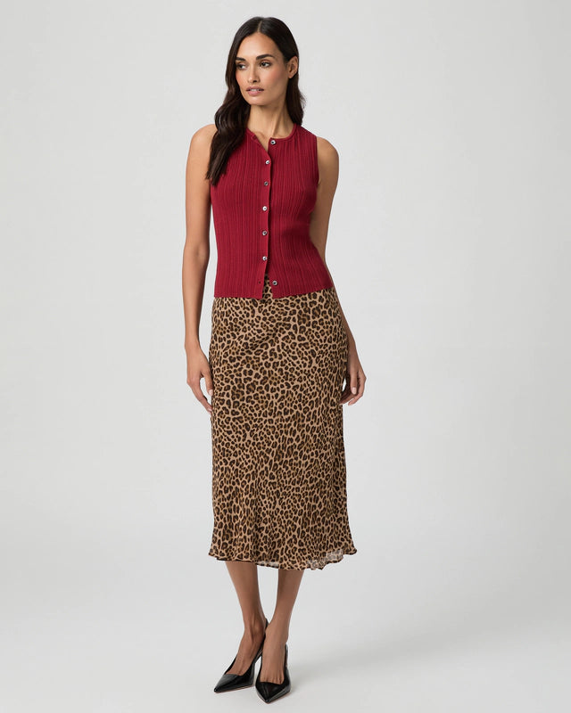 Woman wearing a red sleeveless top and leopard print skirt from Paige