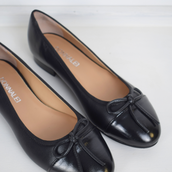 Black ballet pump with patent black toe and bow detail