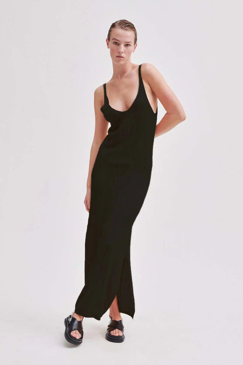 BBlack long loose knit dress with sewn in wave design and narrow straps and V neckline