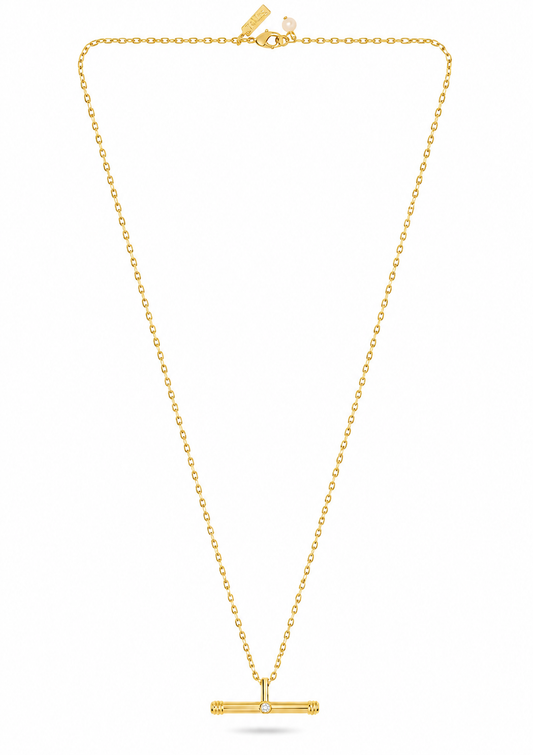 A delicate yellow gold chain necklace with a small horizontal bar pendant featuring a central clear gemstone, displayed on a clean white background.