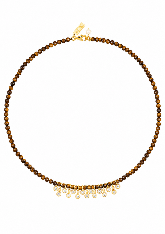 A beaded necklace featuring round brown and golden-brown tiger's eye beads with a fringe of gold-toned settings holding clear teardrop gemstones, shown against a plain white background.