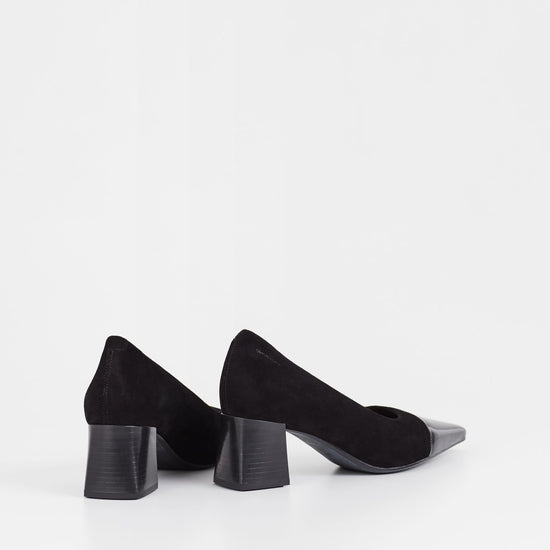 Black suede pumps with stacked black heel and pointed contrast black patent toe