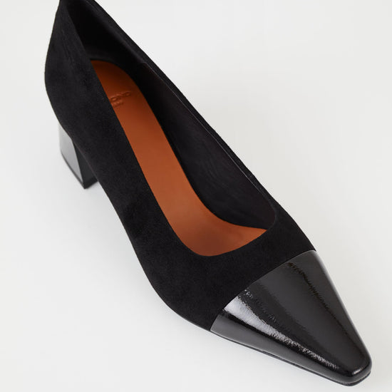 Black suede pumps with stacked black heel and pointed contrast black patent toe