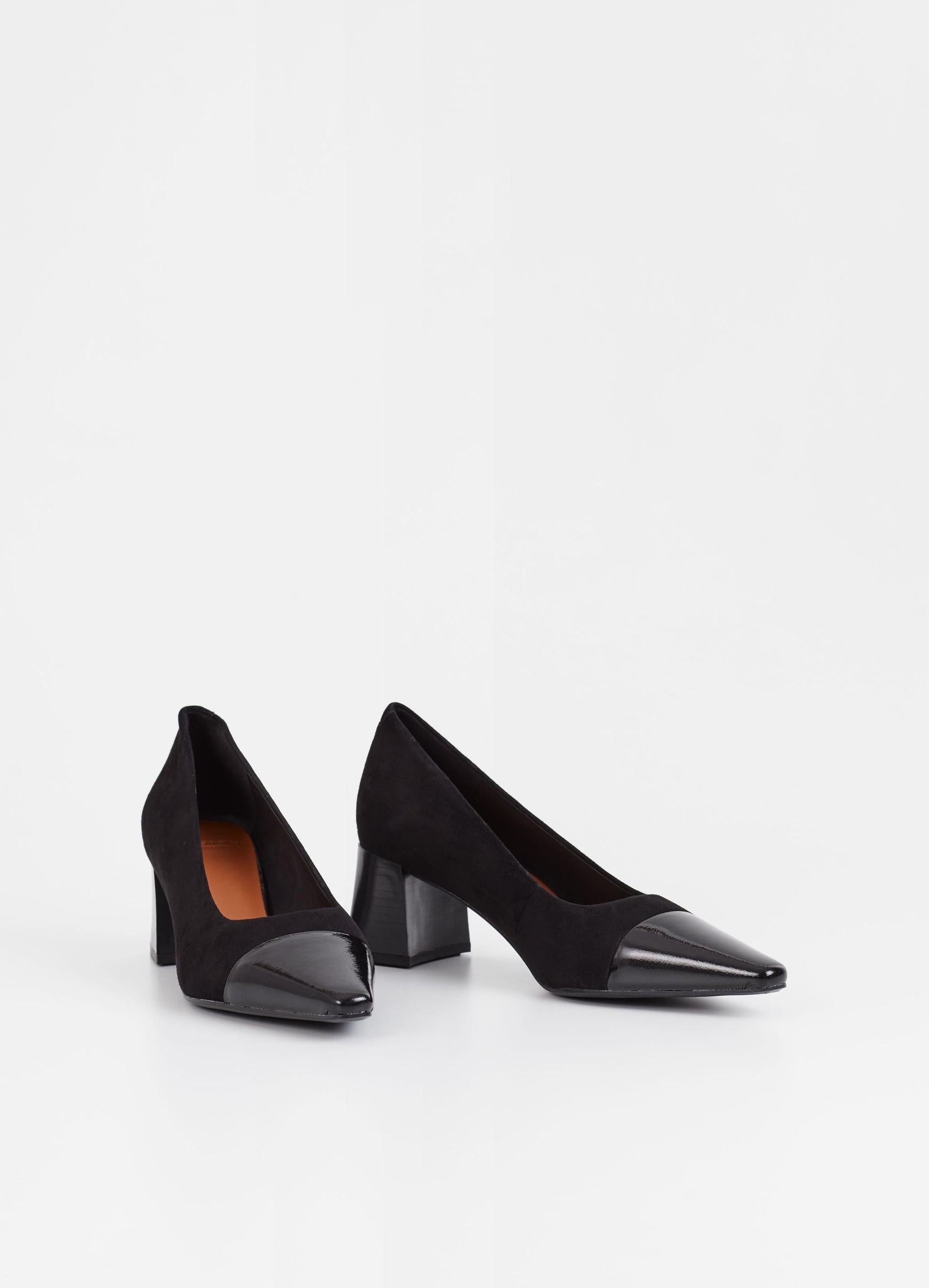 Black suede pumps with stacked black heel and pointed contrast black patent toe