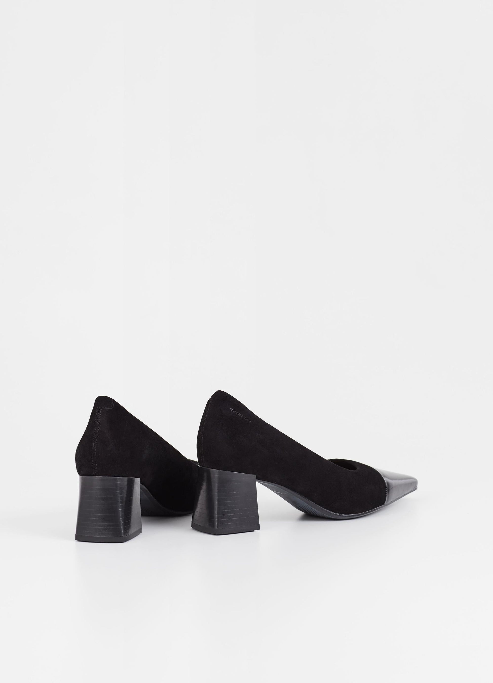 Black suede pumps with stacked black heel and pointed contrast black patent toe