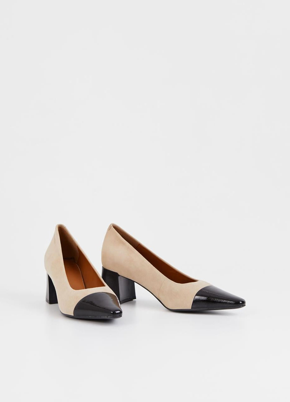 Beige suede pumps with stacked black heel and pointed contrast black patent toe