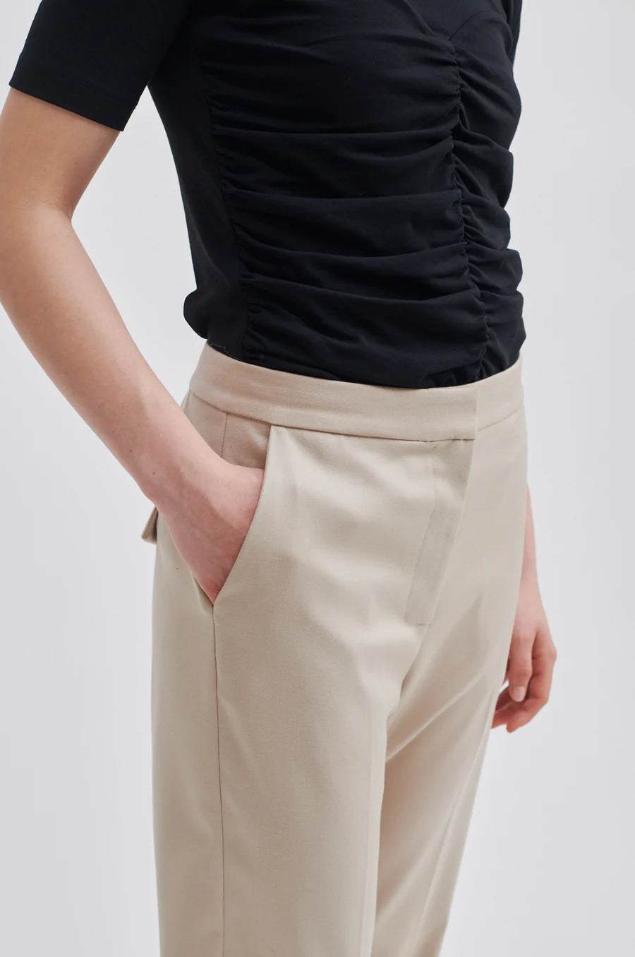 Beige straight leg trousers with flat front and zip fastening