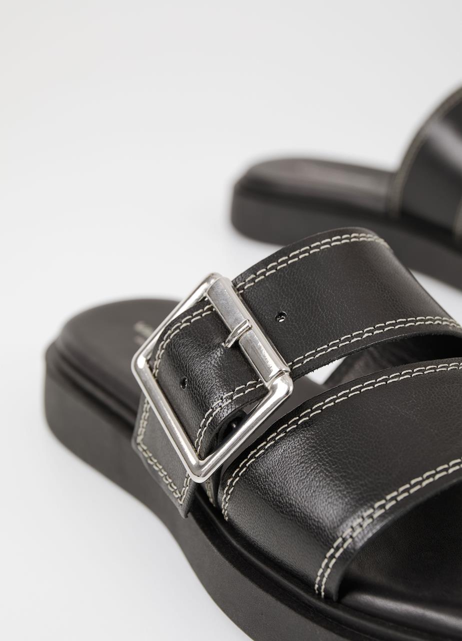 Black leather slider with white stitching and large silver toned buckle