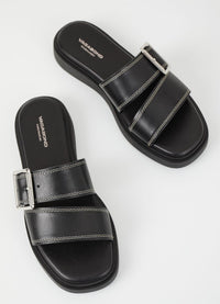 Black leather slider with white stitching and large silver toned buckle