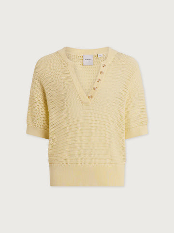Yellow textured sweater on a light gray background