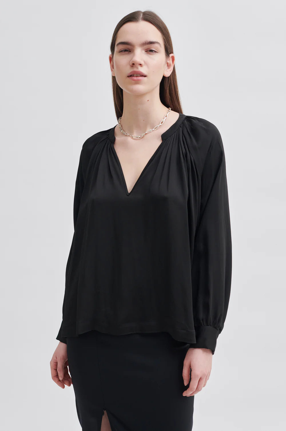 Black satin like blouse with notch neck and raglan sleeves with double button cuff