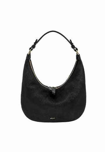 A black hobo shoulder bag with a curved silhouette, featuring a top zipper, a single shoulder strap, and a small gold logo on the front, set against a plain white background.