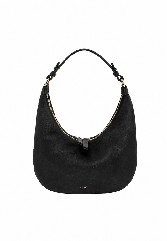 A black hobo shoulder bag with a curved silhouette, featuring a top zipper, a single shoulder strap, and a small gold logo on the front, set against a plain white background.