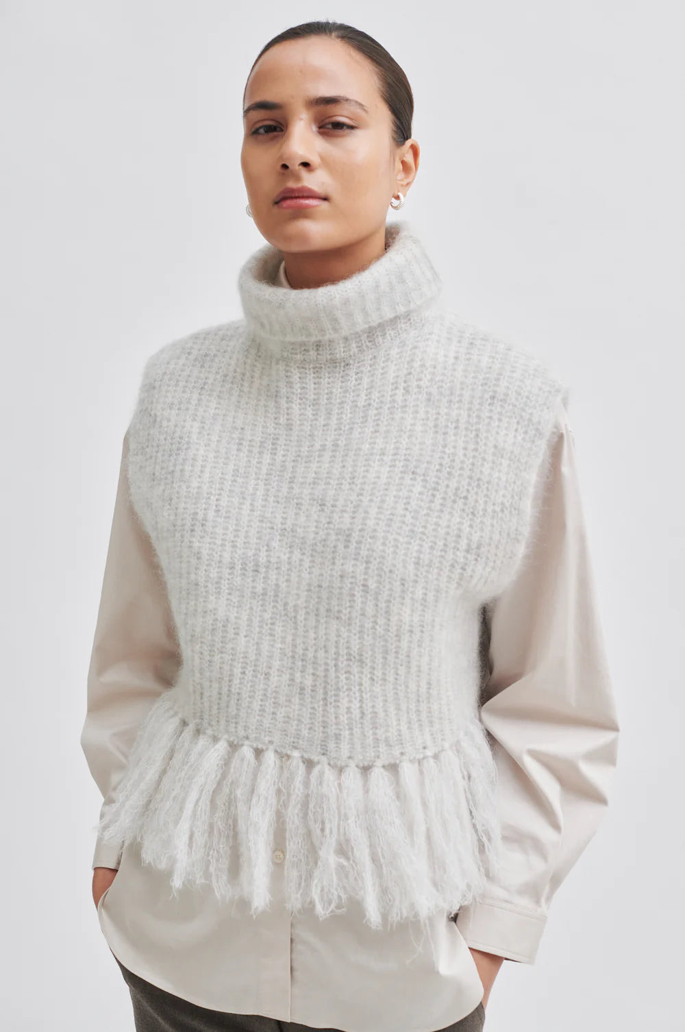 Light grey turtleneck knit with fringe hem