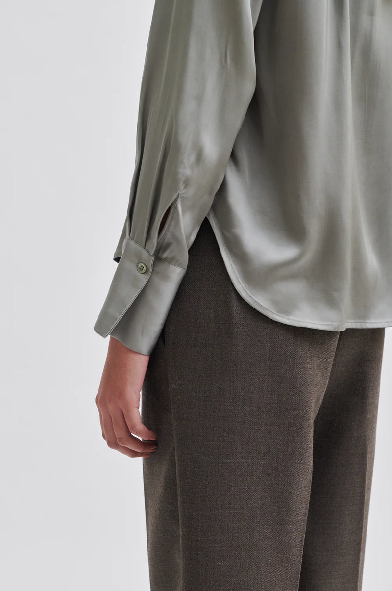 Light grey green satin shirt with classic collar hidden placket long sleeves and rounded dropped hem