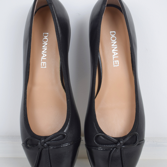 Black ballet pump with patent black toe and bow detail