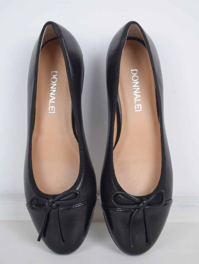 Black ballet pump with patent black toe and bow detail