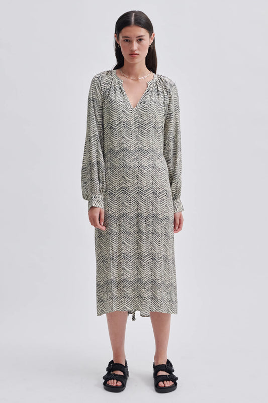 Notch neck midi dress with long gathered sleeves fabric self tie belt and ecru background with black zig zag printed fabric