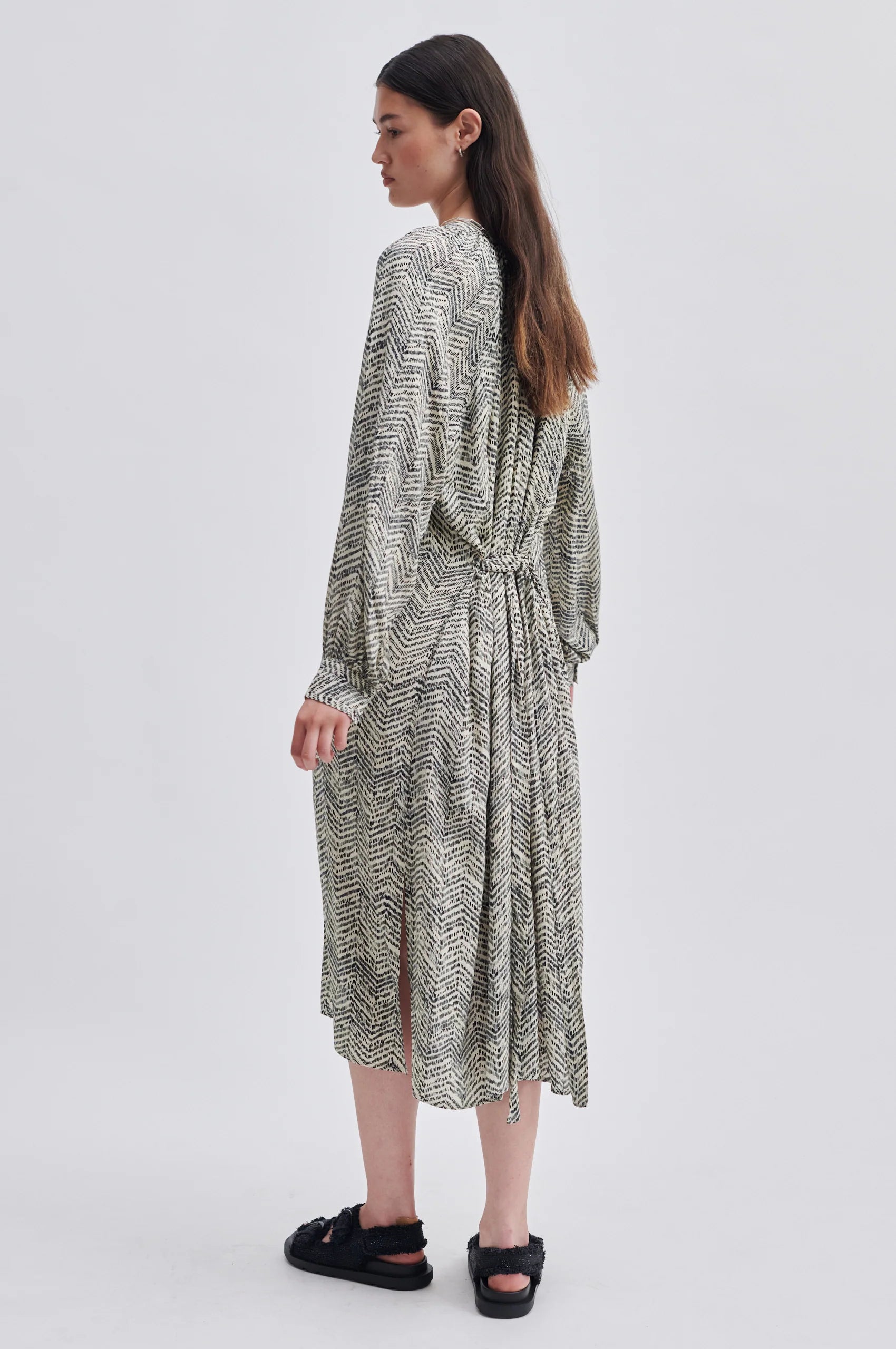 Notch neck midi dress with long gathered sleeves fabric self tie belt and ecru background with black zig zag printed fabric