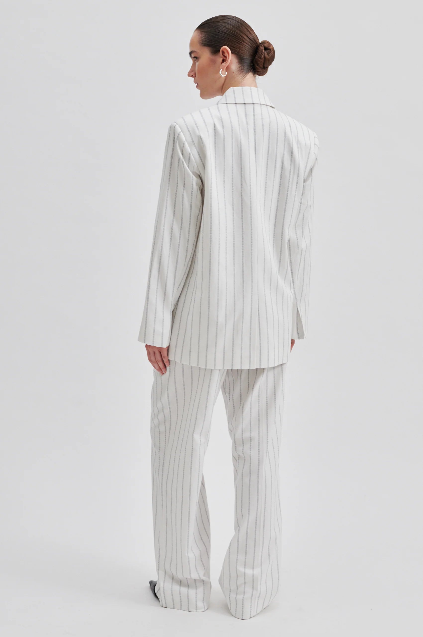 Off white single breasted blazer with generous overlap long sleeves and single silver button fastening with contrast stripe