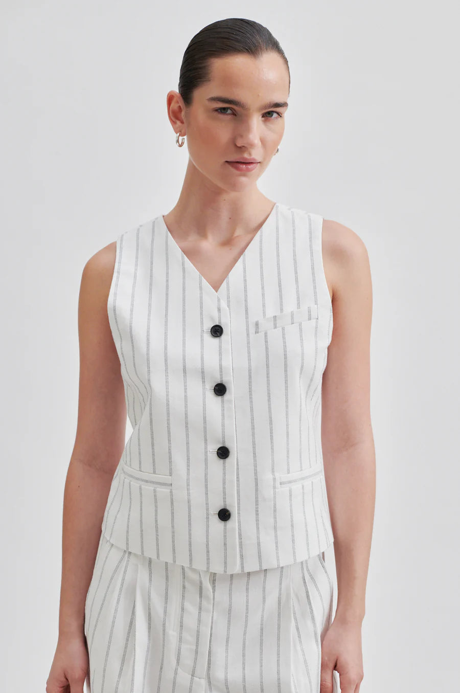Off white V neck waistcoat with pinstripe and contrast black buttons