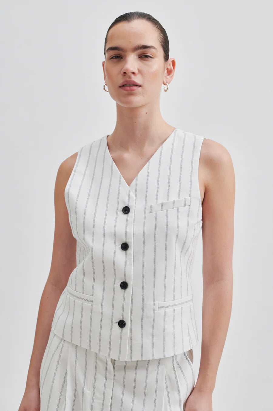 Off white V neck waistcoat with pinstripe and contrast black buttons