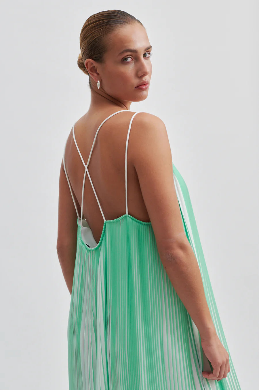 Green and white plisse swing dress with thin double white straps that cross over at the back long midi length