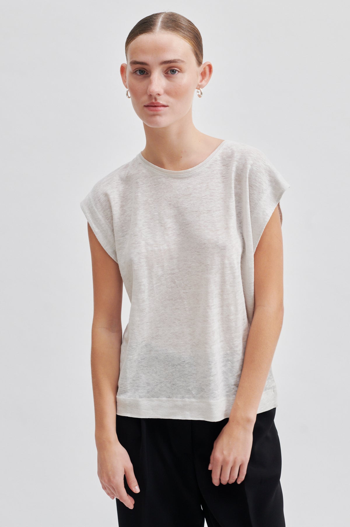 white t-shirt with deep arm holes and round neck model shot