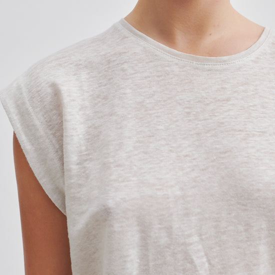 white t-shirt with deep arm holes and round neck close up