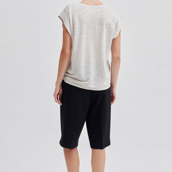 white t-shirt with deep arm holes and round neck rear view