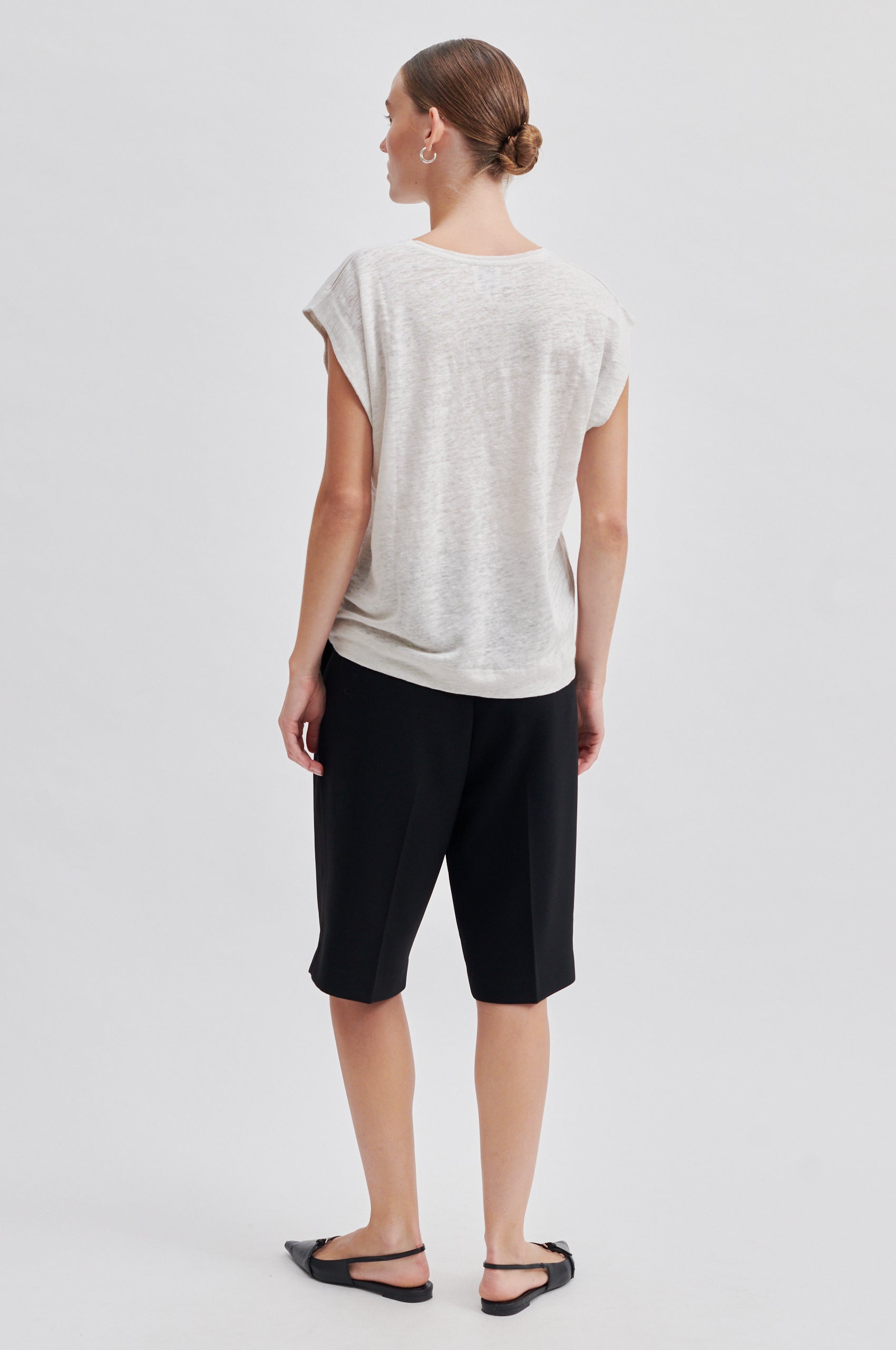 white t-shirt with deep arm holes and round neck rear view