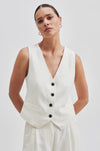 Off-white waistcoat with black buttons and front welt pockets