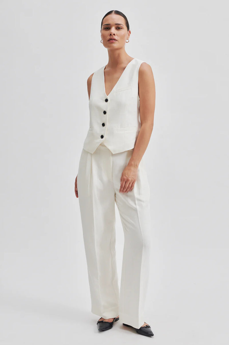 Off-white waistcoat with black buttons and front welt pockets