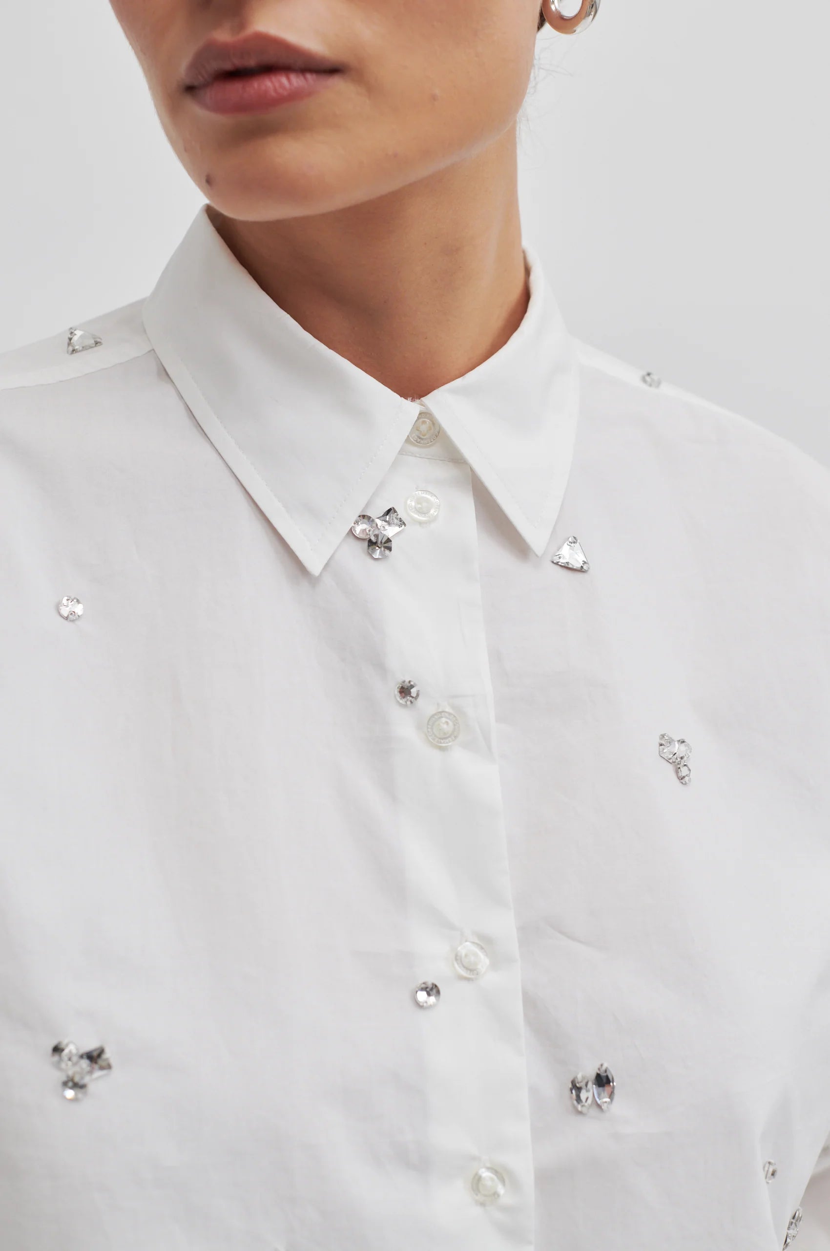 Cropped boxy white long sleeved shirt with scattered sewn on chunky gems