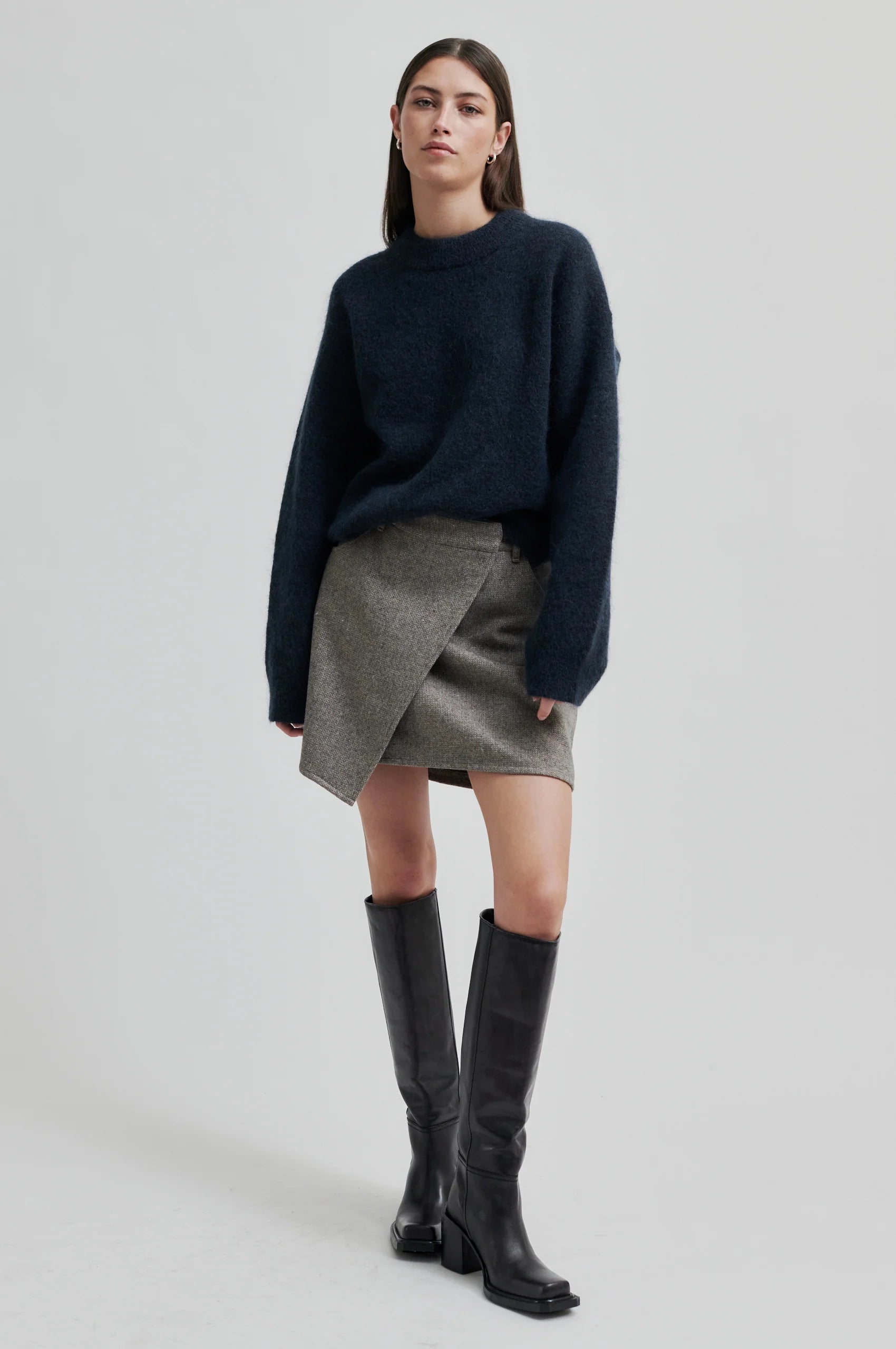 Knit styled with a short skirt and long boots