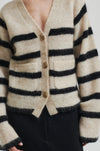 beige mohair blend cardigan with 3 buttons, 2 patch pockets and long sleeves with black stripes  close up