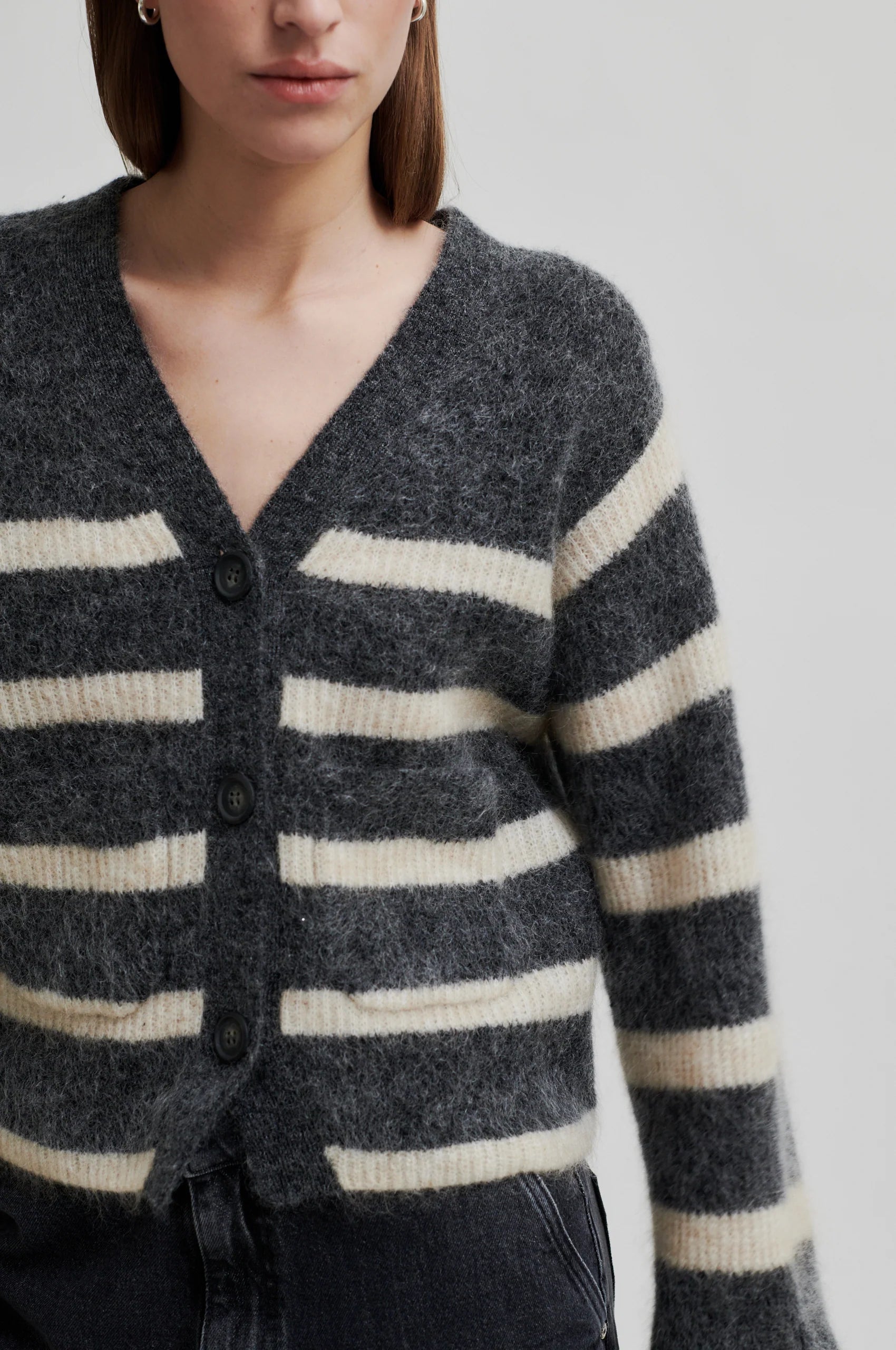 dark grey mohair mix cardigan with 3 buttons, wide long sleeves and 2 front patch pockets close up