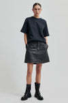 black leather short skirt with belt loops and button/zip fastening model shot