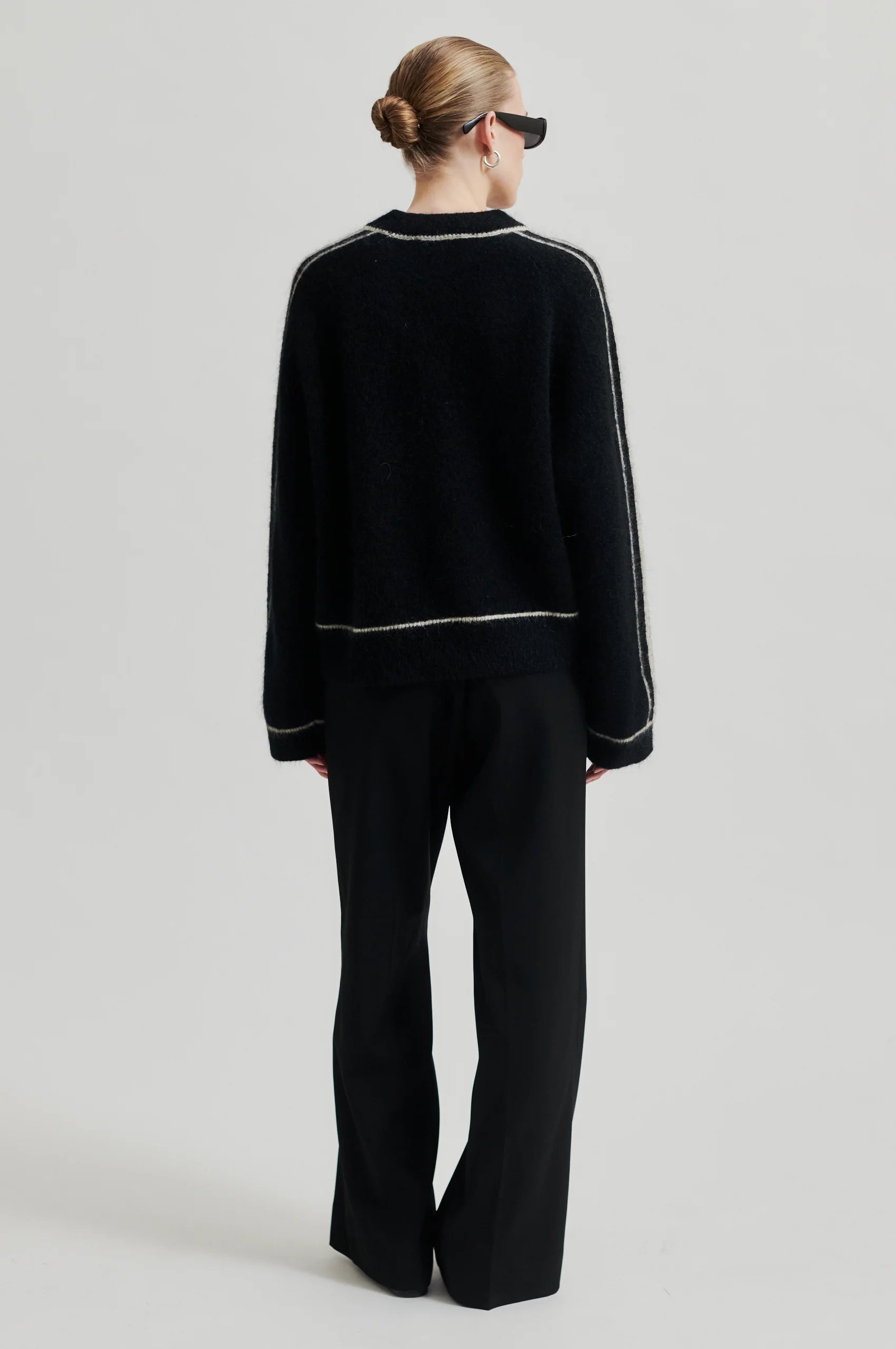 black round neck jumper with contrasting white stripes, long sleeves and ribbing rear view 